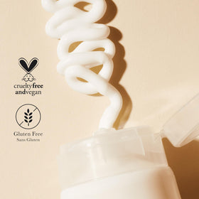 100% PURE lotion held in hand to show 8 oz size and practical everyday scale