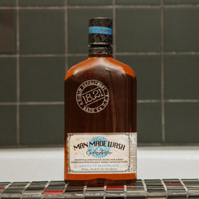 18.21 Man Made bottle next to common items showing 18oz scale