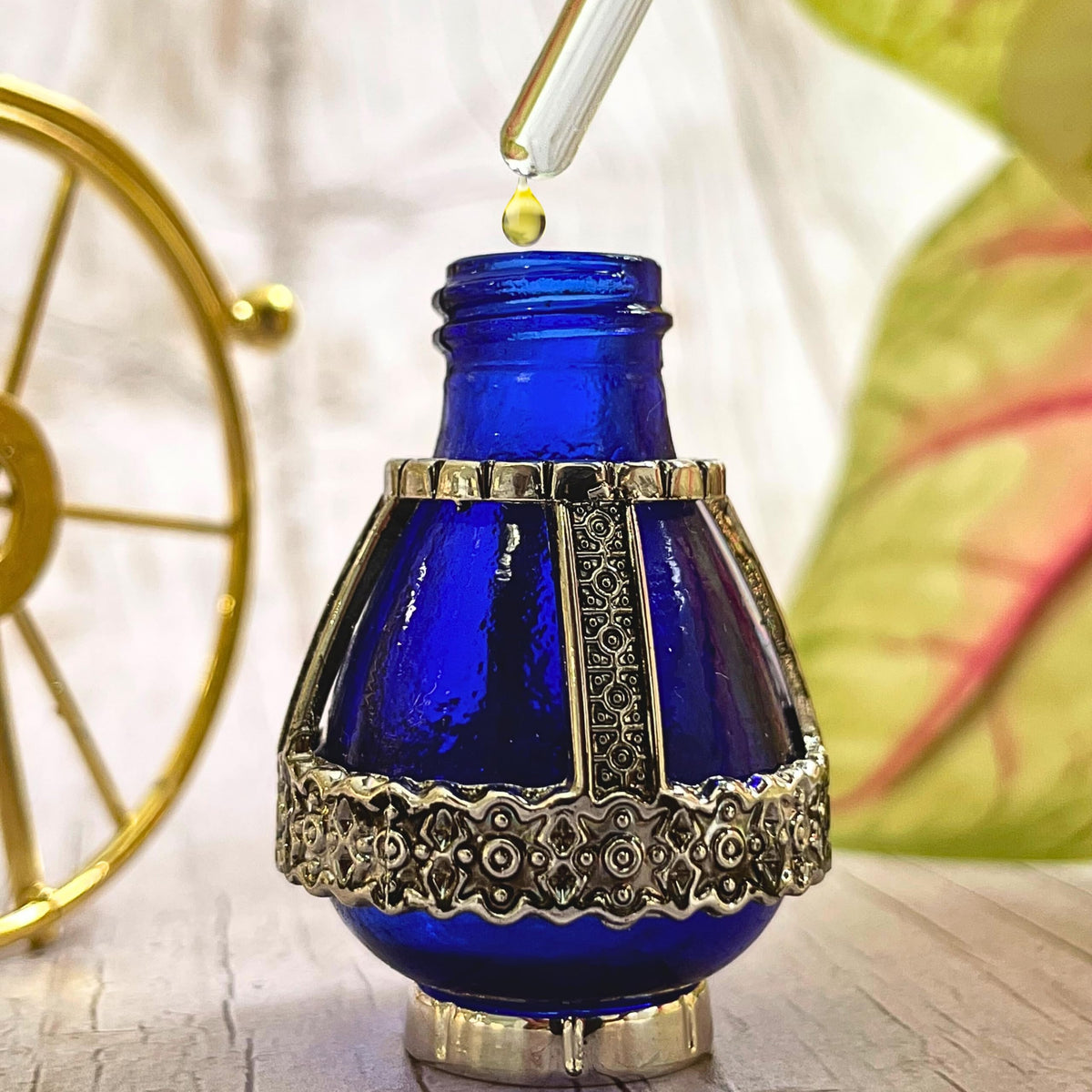3 Arches USA vial beside olive branch highlighting Holy Land olive oil base