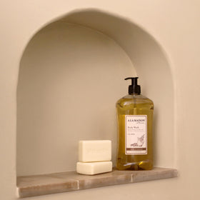 A LA MAISON bottle placed in shower illustrating daily convenience