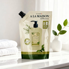 A LA MAISON pouring refill into dispenser demonstrating easy waste reduction