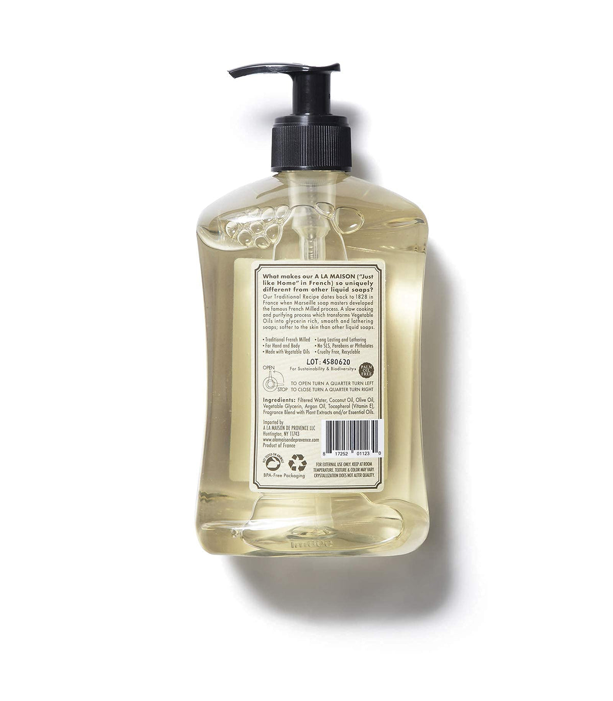 A LA MAISON bottle next to a hand to show scale and easy dispensing convenience