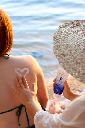 Absolutely Natural family at beach using sunscreen for water resistant protection