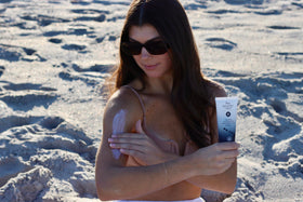Absolutely Natural tube in hand showing 3 oz scale for travel-friendly portability