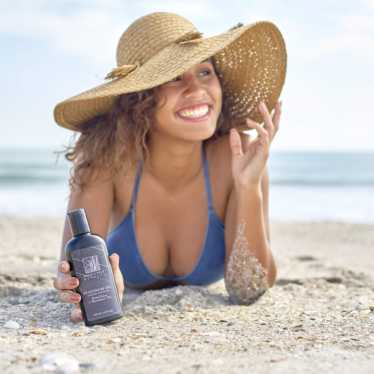 Absolutely Natural bottle on sandy beach lifestyle shot inspiring bronzed glow