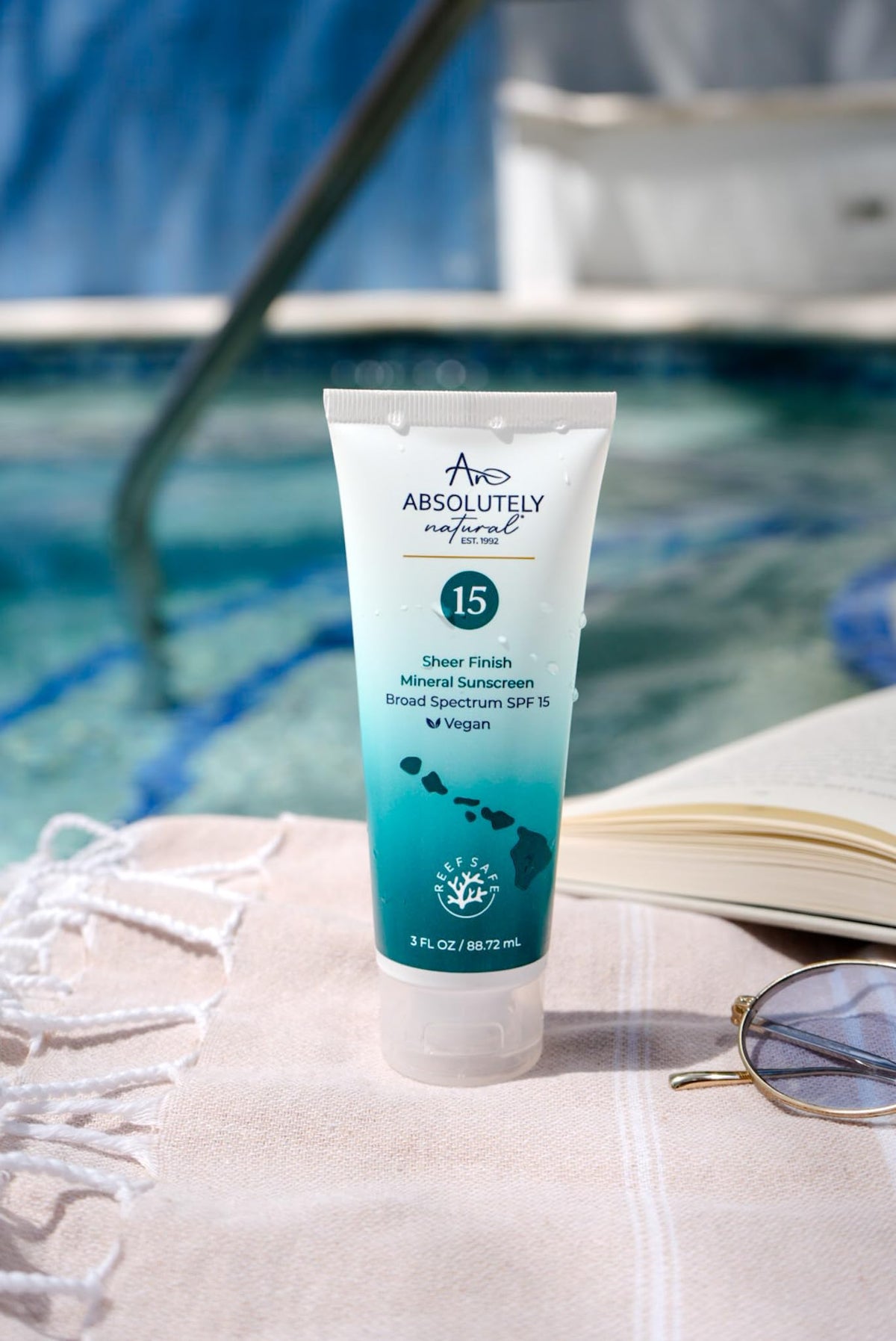 Absolutely Natural tube held in hand illustrating compact 3 oz travel size