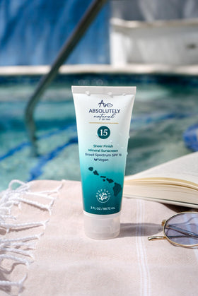 Absolutely Natural tube held in hand illustrating compact 3 oz travel size