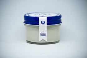 ace high open jar close-up of clay texture, shows pliable matte finish and grip
