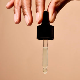 Acure bottle label detail highlighting organic cold-pressed and vegan benefits