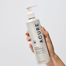 Acure creamy conditioner texture close-up showing rich hydration feel