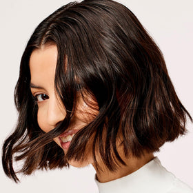 Acure conditioner applied to wet hair demonstrating smooth detangling