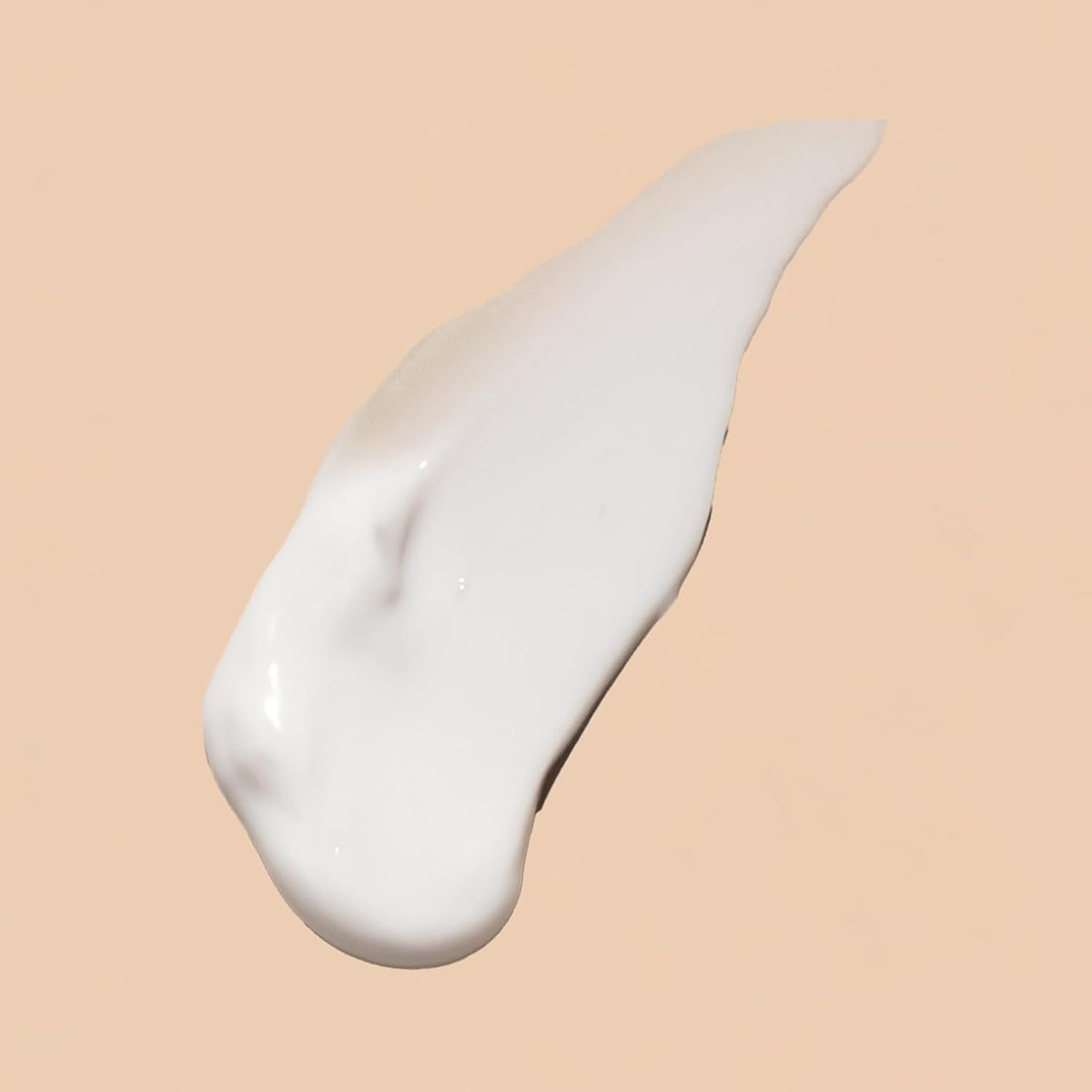 Acure eye cream swatched on hand demonstrating smooth, hydrating finish