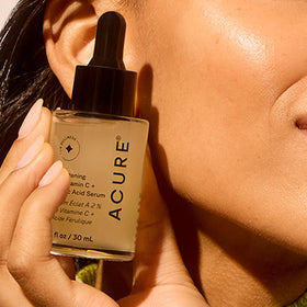 Acure serum being applied in hand demonstrating easy layering and hydration
