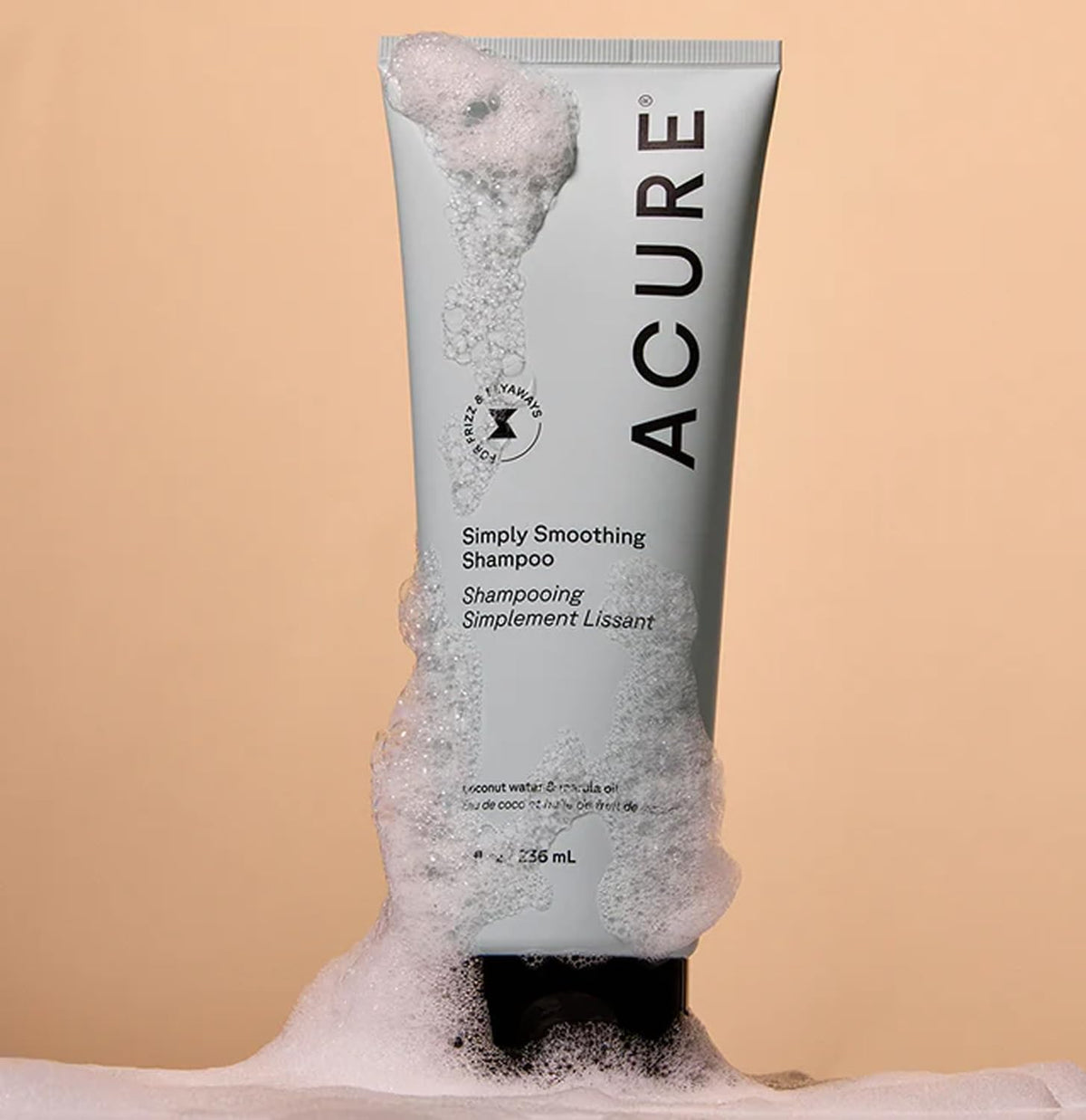 Acure simply smoothing conditioner applied to hair highlighting detangling benefit