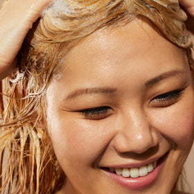 Acure simply smoothing shampoo foam in hand demonstrating gentle cleanse benefit