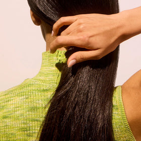 Acure shampoo texture on hand showing lightweight foaming action