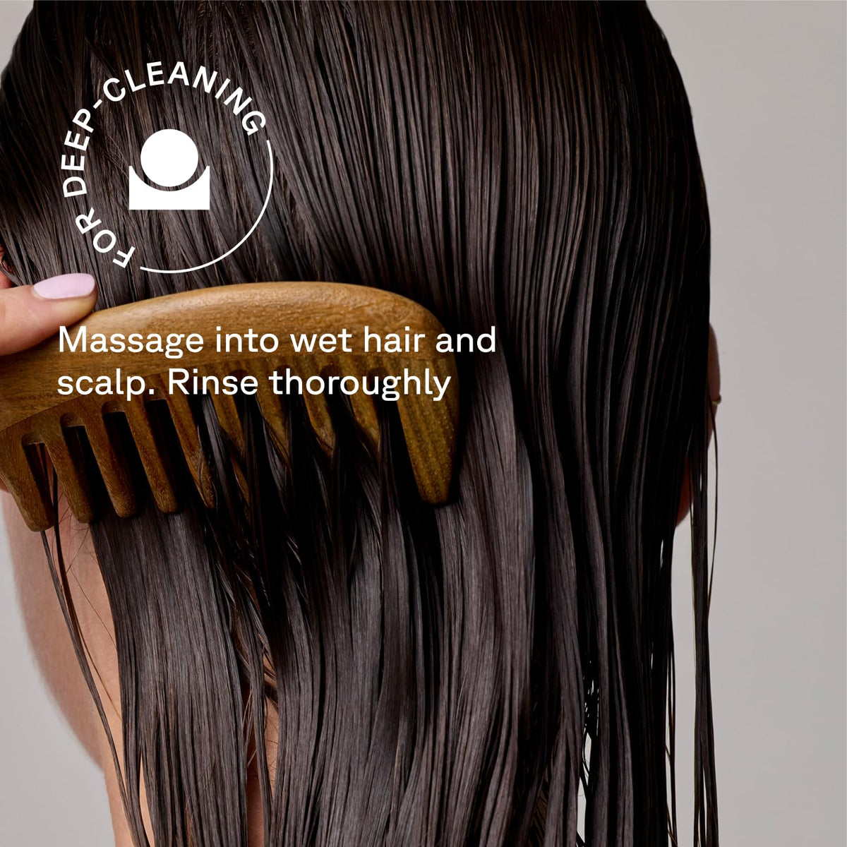 Acure conditioner being applied to mid-lengths demonstrating targeted moisture benefit