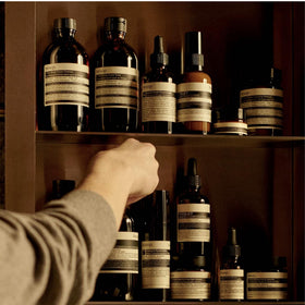 Mandarin rind and ylang-ylang near Aesop cleanser indicating botanical benefit