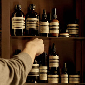 Aesop label closeup revealing ingredient list and recycled bottle messaging