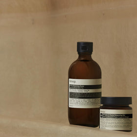 Applying Aesop toner from hand to face demonstrating easy use and hydration