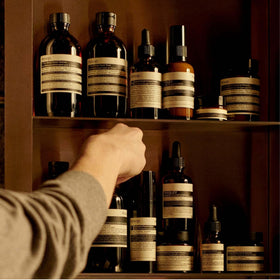 Aesop citrus ingredients arrangement with grapefruit and rinds showing bright, natural scent source