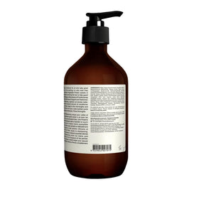 Aesop conditioner next to hand showing 500mL size and travel-friendly volume