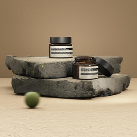 Open jar revealing creamy interior and smooth finish, Aesop barrier repair visual