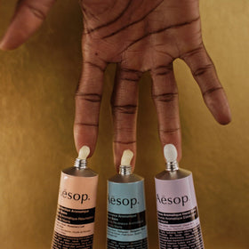Aesop Eleos cream spread on hand demonstrating nourishing, soothing effect