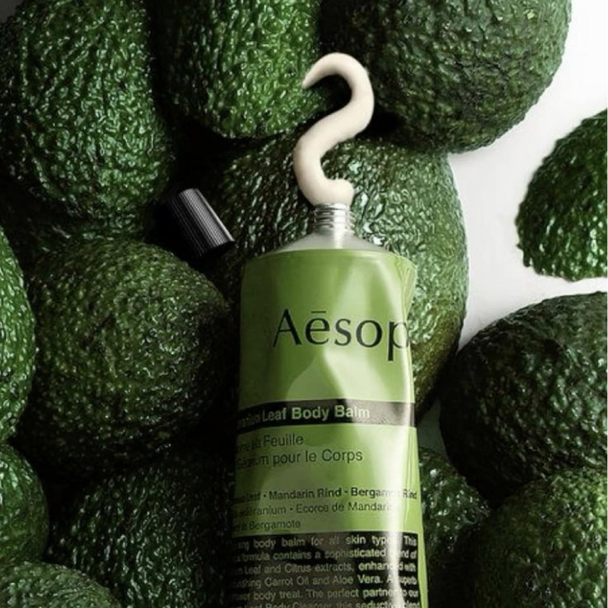 Aesop balm on palm ready to apply, demonstrates lightweight spreadability