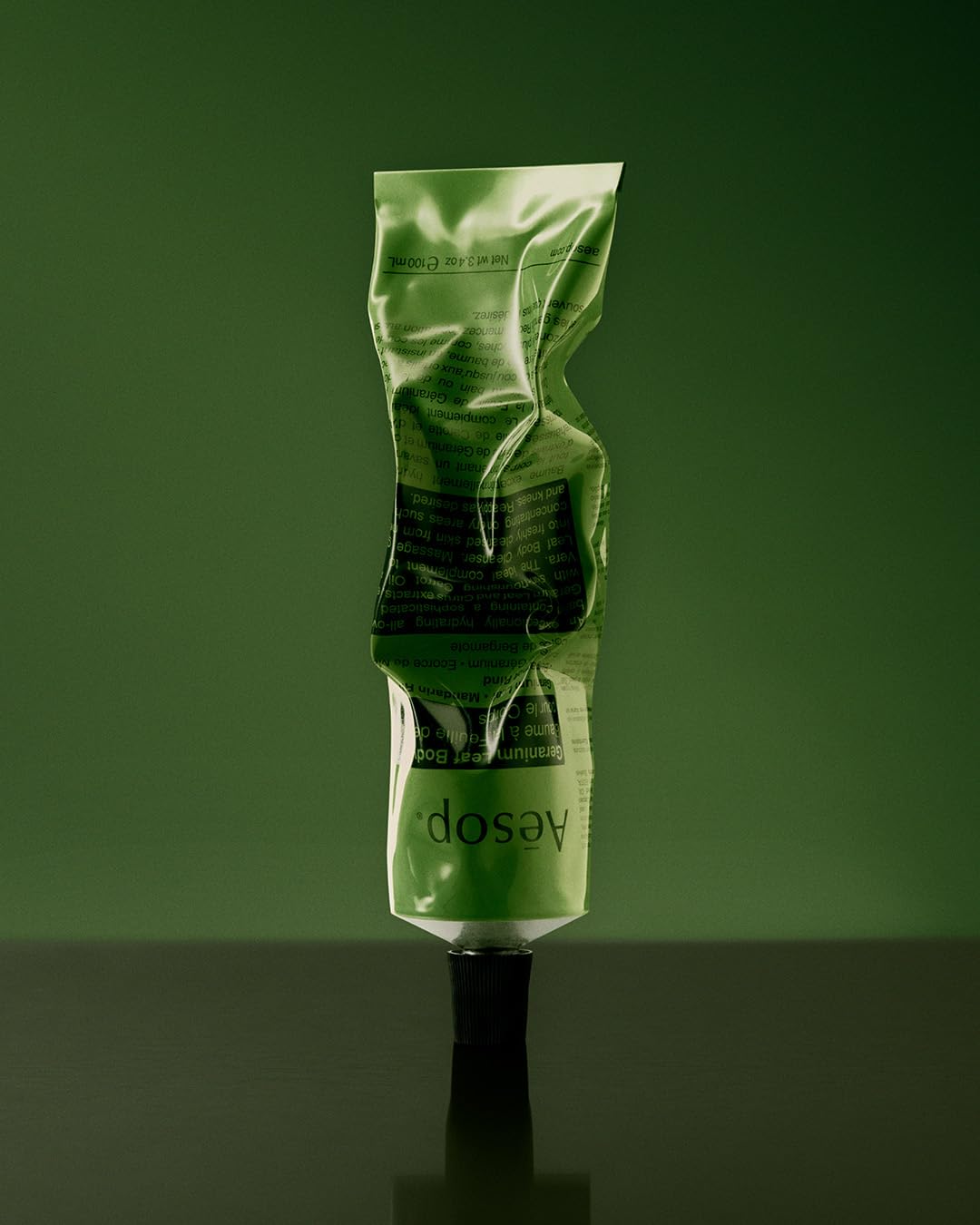 Aesop balm beside mandarin rind, conveys citrus aroma and natural extracts