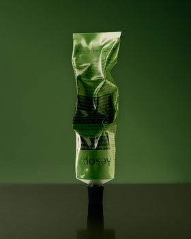 Aesop balm beside mandarin rind, conveys citrus aroma and natural extracts