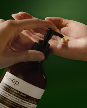 Aesop bottle next to hand showing 500 mL scale and generous size