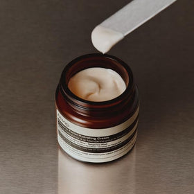 Aesop moisturiser on bathroom shelf with towel, lifestyle shows everyday use