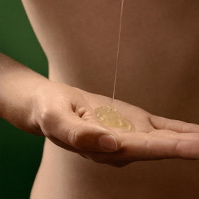 Pouring Aesop body cleanser into palm illustrating easy dispensing and quick rinsing benefit