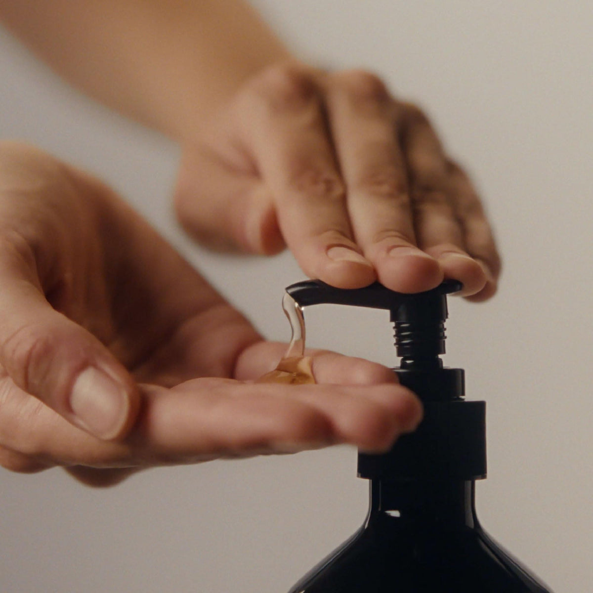 Aesop cleanser dispensed on hand demonstrating easy spreadability