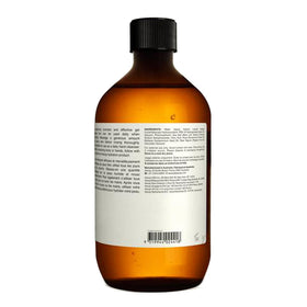 Aesop 500ml bottle next to a hand for scale and refill convenience