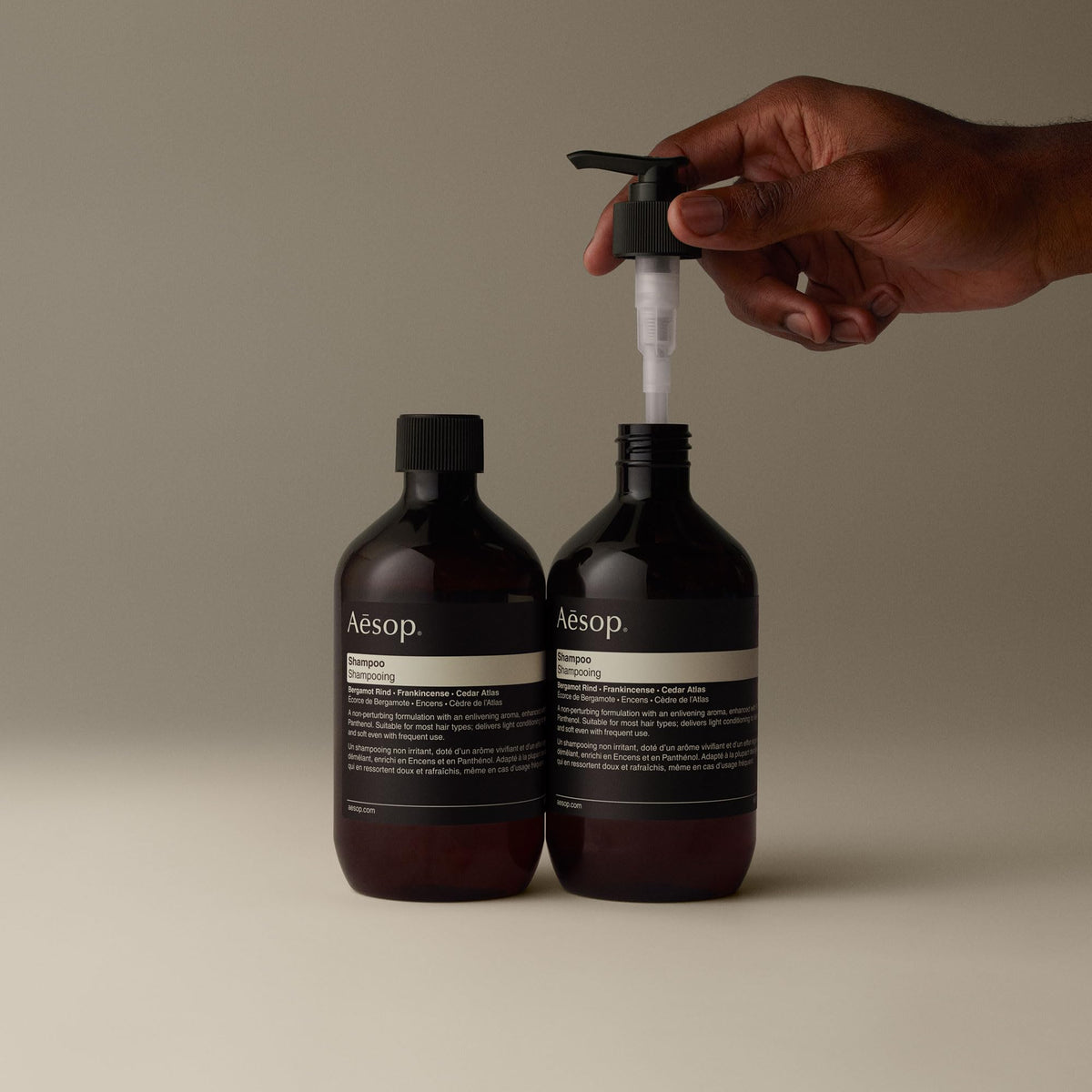 Aesop bottle beside common items for scale, practical benefit: conveys 500 mL size