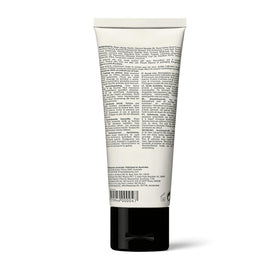 Aesop size scale with 75ml tube beside coins for compact travel convenience