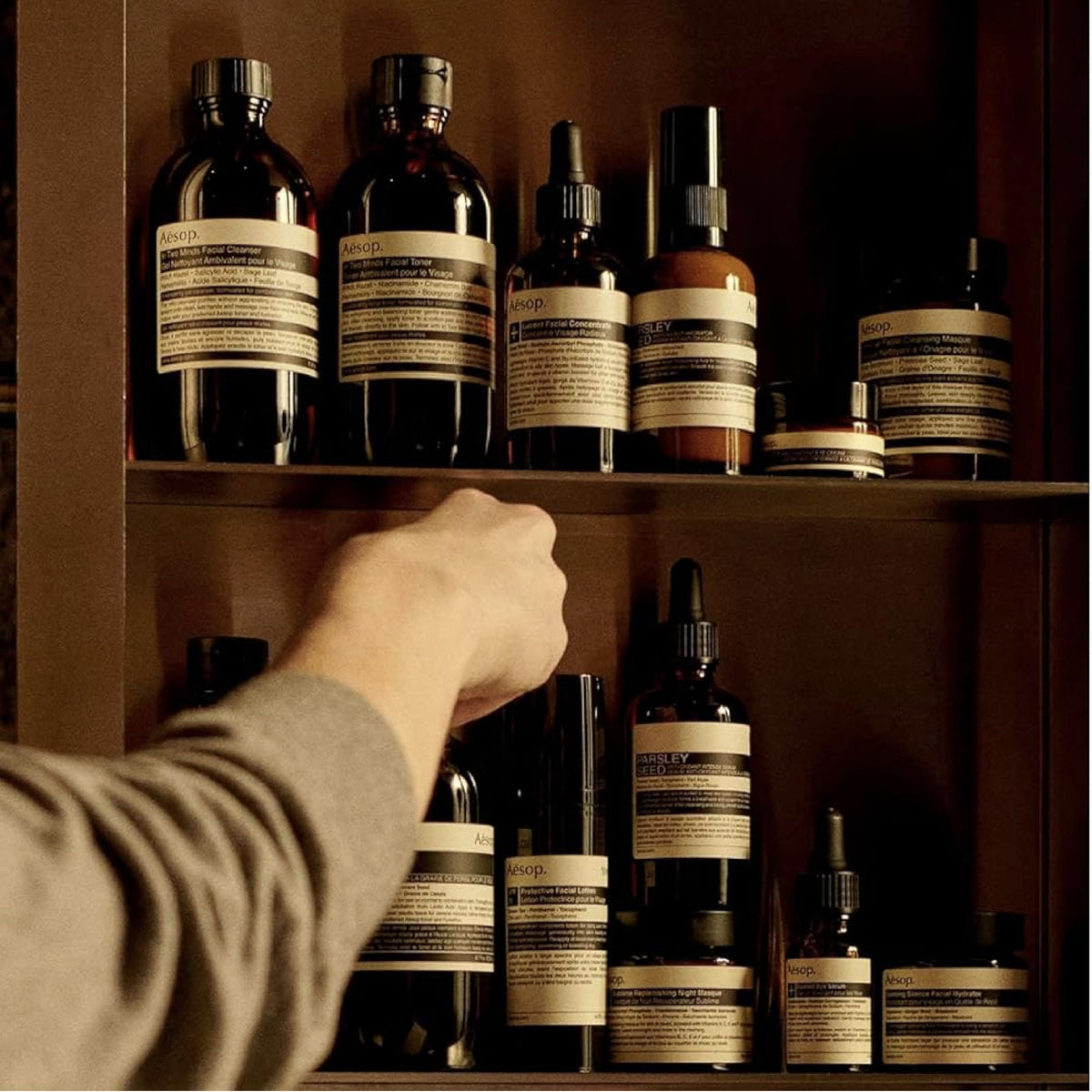 Applying Aesop balm to damp hair for styling and frizz control benefit