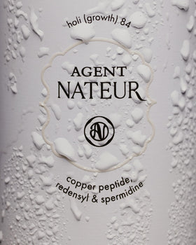 Agent Nateur holi (growth) 84 on bathroom shelf in lifestyle setting showing daily routine
