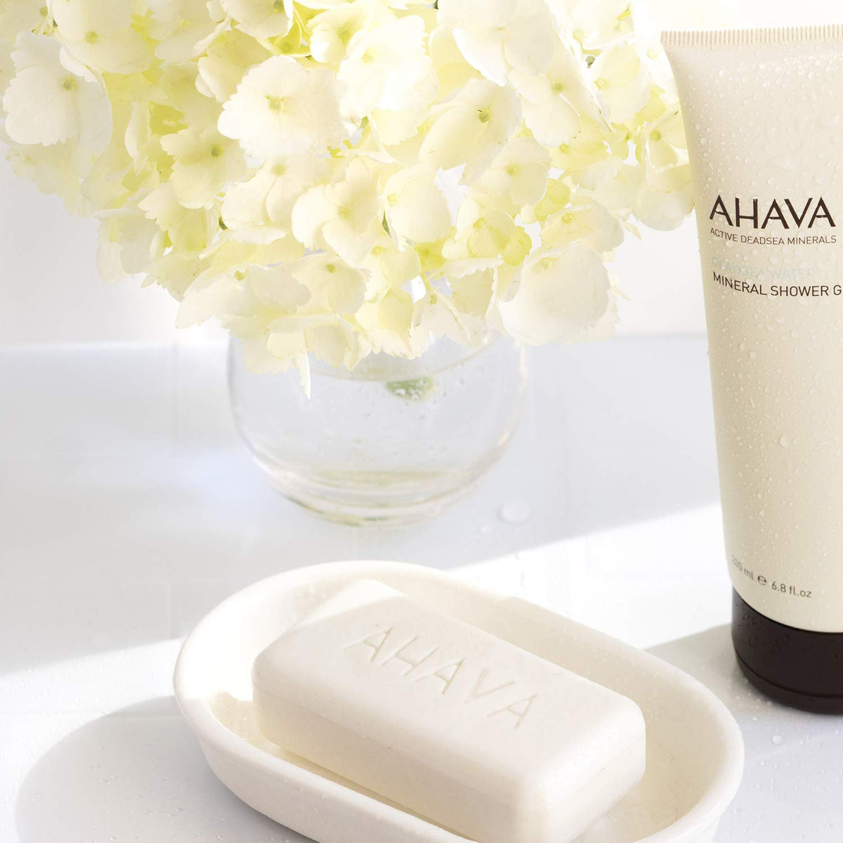 AHAVA soap bar in hand to show size and easy face-and-body use