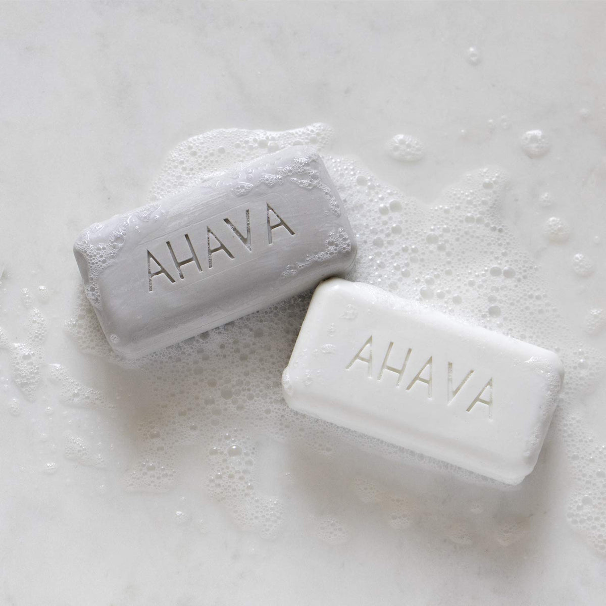 AHAVA close-up of a single Dead Sea salt soap bar highlighting mineral texture