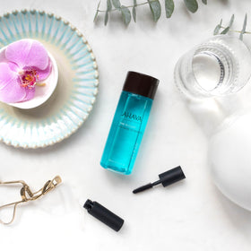AHAVA in-use cotton pad removing waterproof mascara, demonstrating effective, low-rub removal benefit