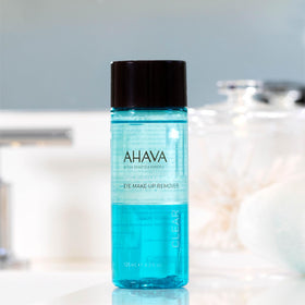 AHAVA next to travel items for size comparison, showing portable 4.2 fl oz bottle convenience benefit