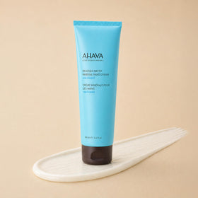 AHAVA tube next to everyday items showing 5.1 fl oz scale and travel-ready benefit