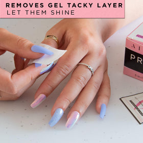 AIRRE NAILS pad in use wiping cured gel to remove sticky layer and restore shine