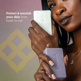 Alaffia soap bars arranged on bathroom counter, suggests everyday hand and body use