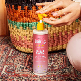 Alaffia bottle held in hand for scale and travel-friendly size benefit