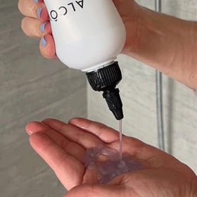 Alcôve hydrating shampoo in hand to show 10.1oz size and portability