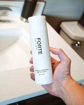 Alex Costa conditioner being applied in shower for smoother hair